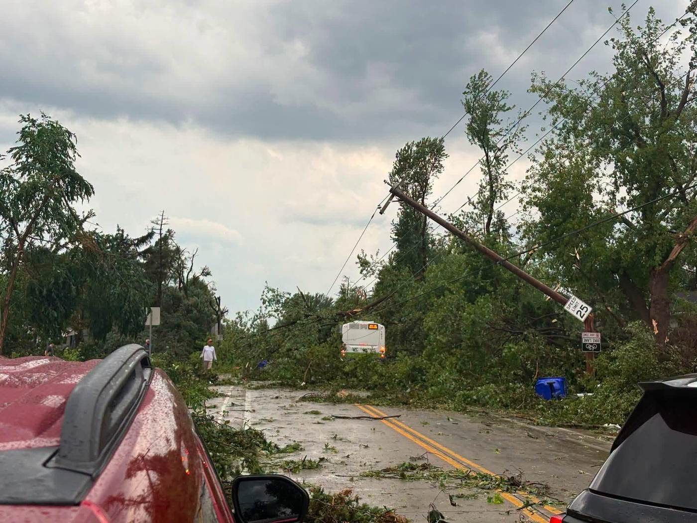 Tornado damage in the Fox Valley: a downed power pole, snapped trees and storm debris blocking a residential street near Appleton, Wisconsin
